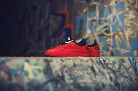 Red and black sneakers By Alexander McQueen x Puma on abstract background. Krasnoyarsk, Russia - December 19, 2017のeditorial素材