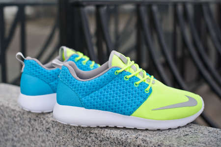 Colorful Nike Roshe Run running shoes, sneakers, trainers close up view, shot outdoors on grey urban background. Sport and casual footwear concept. Krasnoyarsk, Russia - April 16, 2015のeditorial素材