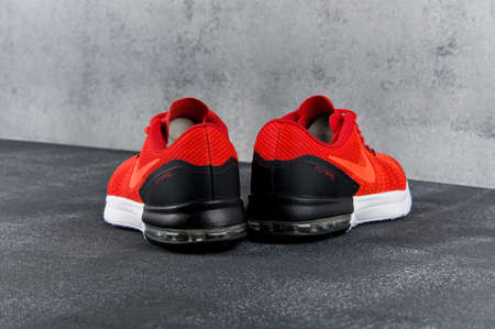 Red and black Nike Air Max Typha sneakers, running shoes, trainers close up view, shot on grey abstract background. Sport and casual footwear concept. Krasnoyarsk, Russia - May 12, 2017のeditorial素材