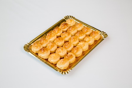 cupcakes in a gold tray on white backgroundの写真素材