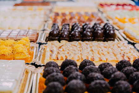 many different sweets prepared on the metal table of a food factory