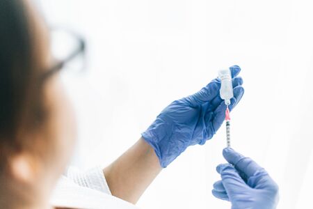 nurse or doctor preparing a syringe for an injectionの写真素材