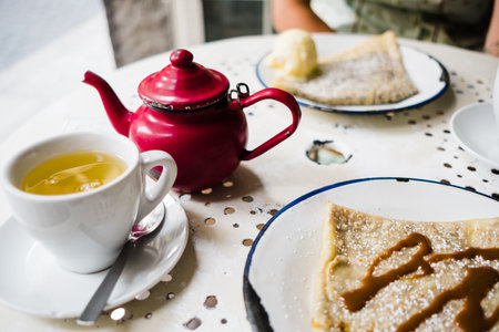 breakfast in a coffee shop with crepes and teaの写真素材