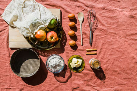 Flat lay of baking dessert ingredients on a pink tableclothの写真素材