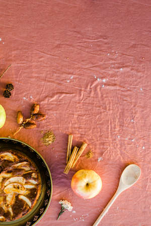 Flat lay of a cake and ingredients in vertical with copy space. Pink backgroundの写真素材