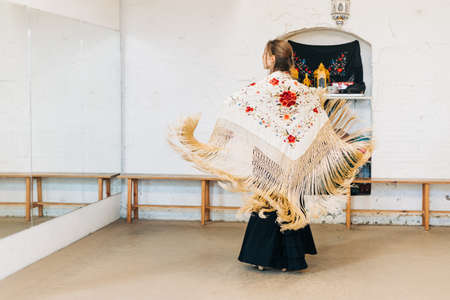 Flamenco woman dancer on her back with manila shawl in motionの写真素材