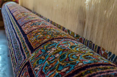 Multicolor Persian carpet inside in the manufacture from Srinagar, Jammu and Kashmir, India.の写真素材