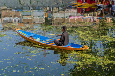 SRINAGAR, INDIA - JULAY 30, 2017: Indian gondolier with a traditional boath. For centuries the Shikaraâs have been serving as the taxi boats of the Dal lake.のeditorial素材