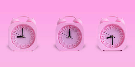 Pink Clock Isolated On Pastel Pink Background. 09:00 Hours, 08:30 Hours, 12:00 Hours. Alarm Clockの写真素材