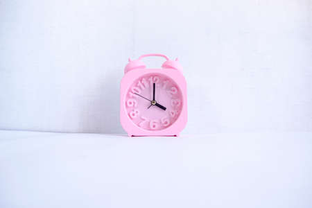 Pink Alarm Clock Isolated On White Background. time is 04:00 o clock.
