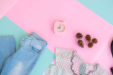 Women's clothing base layout, Outer on pale mint pastel background. Lifestyle concept. alarm clock. small bag. bagの写真素材