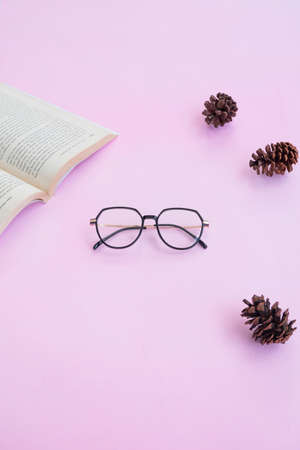 Fashion and beauty concept lying flat with square glasses, women's accessories on pink background.の写真素材