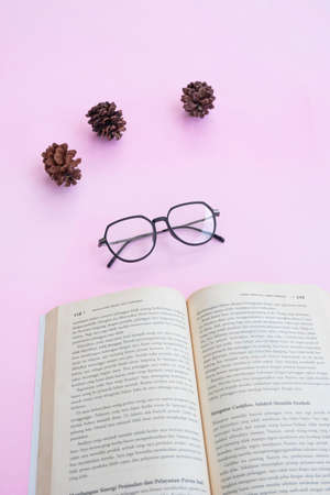 Fashion and beauty concept lying flat with square glasses, women's accessories on pink background.の写真素材