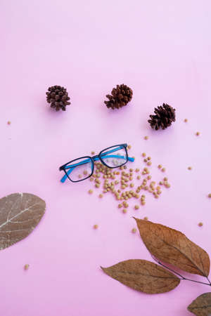 Fashion and beauty concept lying flat with square glasses, women's accessories on pink background.の写真素材