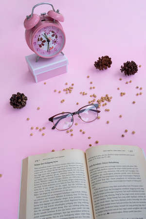 Fashion and beauty concept lying flat with square glasses, women's accessories on pink background.の写真素材