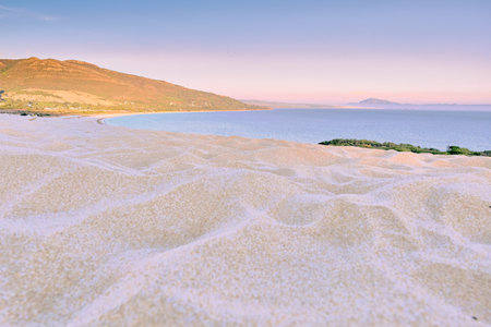 Valdevaqueros beach in Cadiz Andalucia from sand dune at sunset violet colors and white sandの写真素材