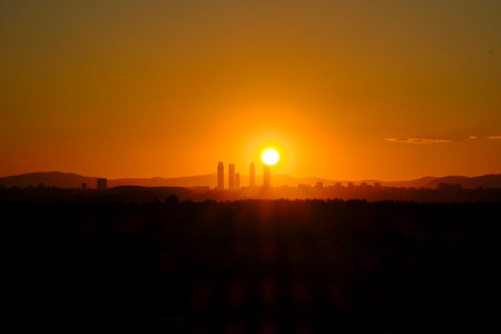 Madrid city skyline in silhouette sun and mountains on background five towers business area skyscrapersの写真素材