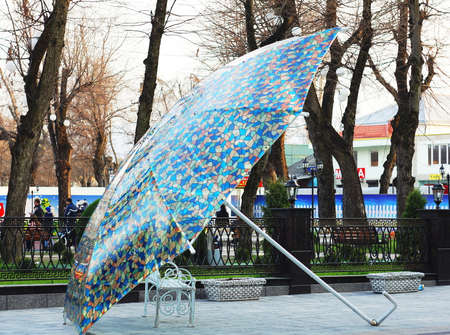 Bench under the umbrella. Street art object in the historic zone of Nalchik. Pedestrian street Kabardinskaya.の写真素材