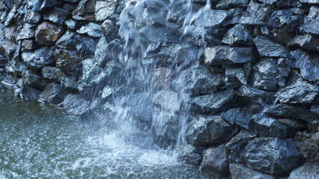 Fountain as artificial waterfall flowing along the stones of rock Northern Caucasian.の写真素材