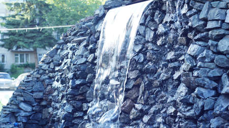 Fountain as artificial waterfall flowing along the stones of rock Northern Caucasian.の写真素材