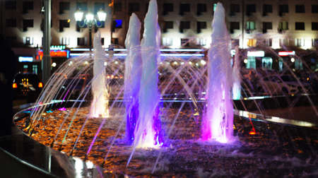 A fountain with color illumination in the evening in the city square "400 anniversary" in Nalchik.の写真素材