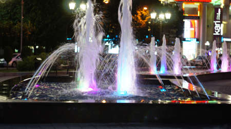 A fountain with color illumination in the evening in the city square "400 anniversary" in Nalchik.のeditorial素材
