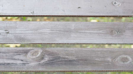 Old wooden boards on a park bench with a pronounced texture of wood fibers.の写真素材