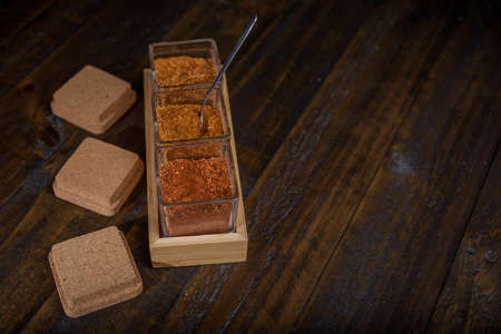 seasoning set on table with spoon and hand servingの写真素材