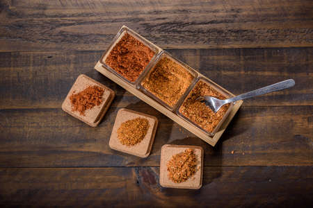 seasoning set on table with spoon and hand servingの写真素材