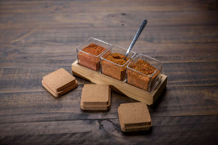 seasoning set on table with spoon and hand servingの写真素材