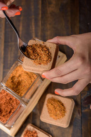 seasoning set on table with spoon and hand servingの写真素材