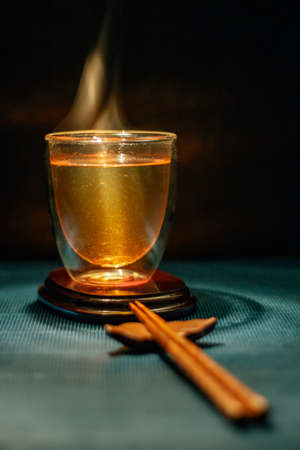 hot healthy drink Hot Tea clear Japanese tea in a glass elegant with chopsticksの写真素材