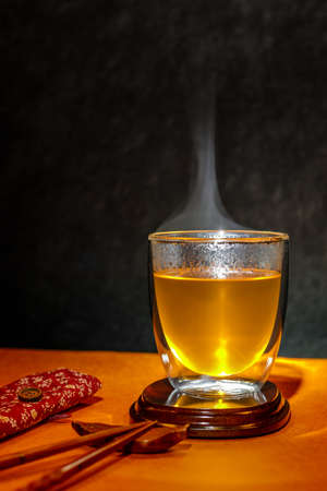 hot healthy drink Hot Tea clear Japanese tea in a glass elegant with chopsticksの写真素材