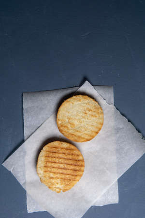 grilled and cut in half burger bun on paper