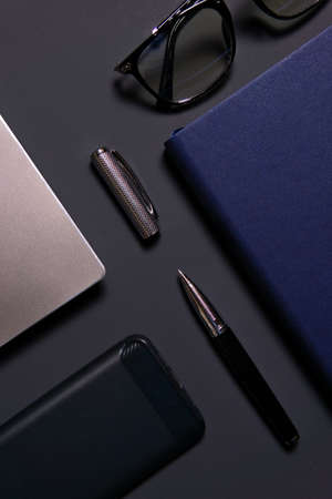 Notebook, laptop, glasses and pen on the table. Concept of business or study.