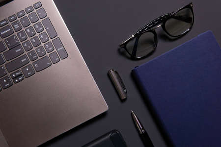 Notebook, laptop, glasses and pen on the table. Concept of business or study.の写真素材