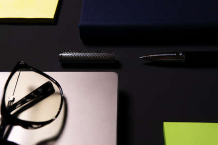 Notebook, laptop, glasses and pen on the table. Concept of business or study.の写真素材