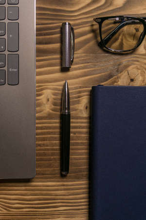 Notebook, laptop, glasses and pen on the table. Concept of business or study.