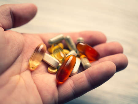 Colorful pills and medicines in the hand