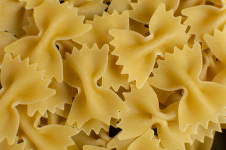 background of some farfalle pasta in the form of bows. texture. pattern