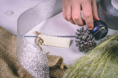 Child holds a handful of pine cones.の写真素材