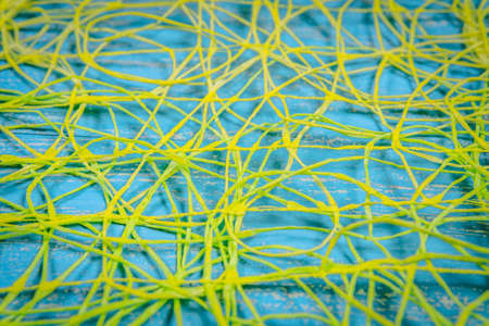 Abstract background of yellow threads on blueの写真素材