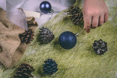 Child holds a handful of pine cones.の写真素材