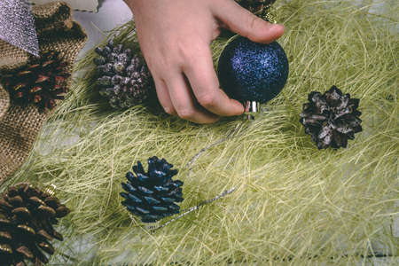 Child holds a handful of pine cones.の写真素材