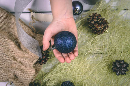 Child holds a handful of pine cones.の写真素材