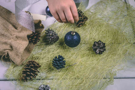 Child holds a handful of pine cones.の写真素材