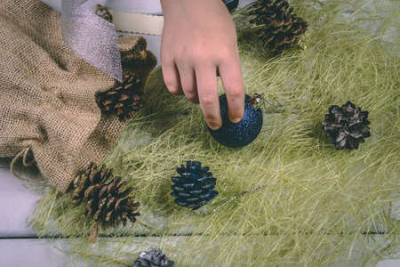 Child holds a handful of pine cones.の写真素材