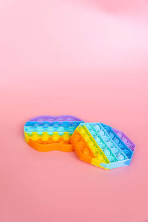colorful silicone antistress sensory toy fidget push   on pink backgroundの写真素材