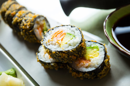 Hot roll fried Sushi Roll with Salmon and Vegetables. Modern sushi recipe in Japan.の写真素材