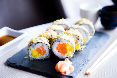 Hot roll fried Sushi Roll with Salmon and Vegetables. Modern sushi recipe in Japan.の写真素材